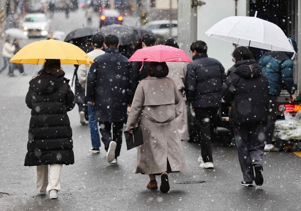 눈이 내린 지난 17일 서울 강남구 강남역 인근에서 시민들이 우산을 쓰고 걷는 모습. (사진=연합뉴스)