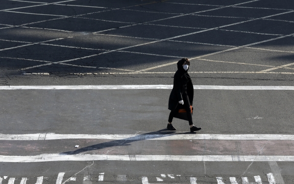 이란이 중동 지역의 신종 코로나바이러스 감염증(코로나19) 거점으로 지목된 가운데 수도 테헤란에서 마스크와 장갑을 착용한 한 여성이 인적이 끊긴 교차로를 건너가고 있다. (사진=AP/연합뉴스)